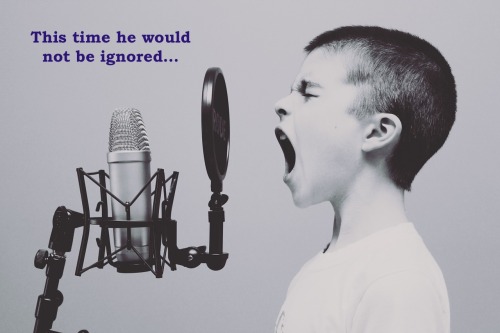 boy yelling into microphone captioned